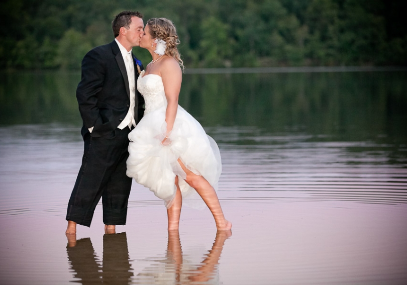 Wedding photo of couple kissing at the lakeshore